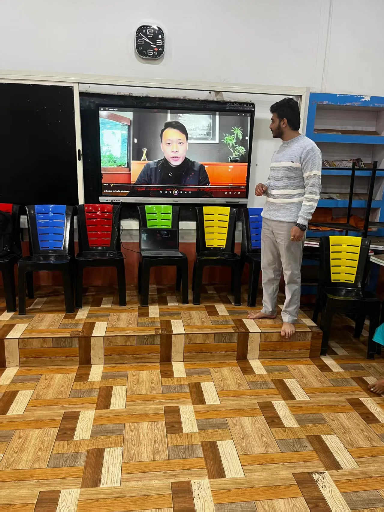 An educator supporting remote foundational learning in an India classroom