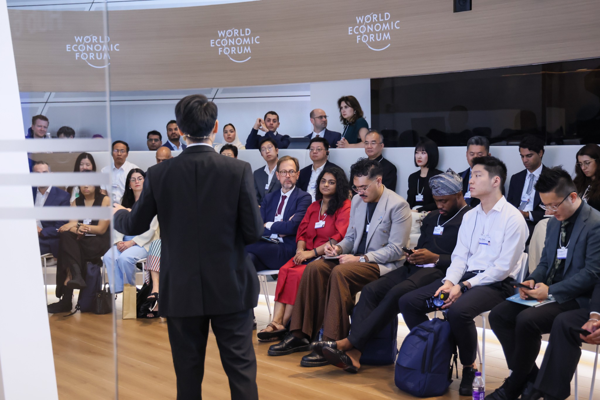A speaker addressing a room during a future-of-work conversation